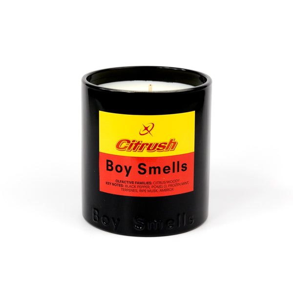 Candle in a black container with a colorful label on a white background
