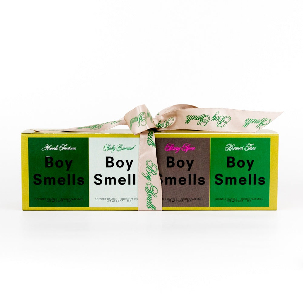 Four 'Boy Smells'candles wrapped in a box with a ribbon on a white background