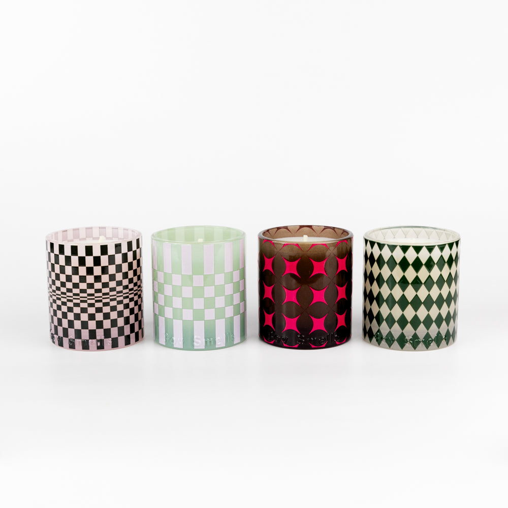 Four 'Boy Smells'candles wrapped in a box with a ribbon on a white background