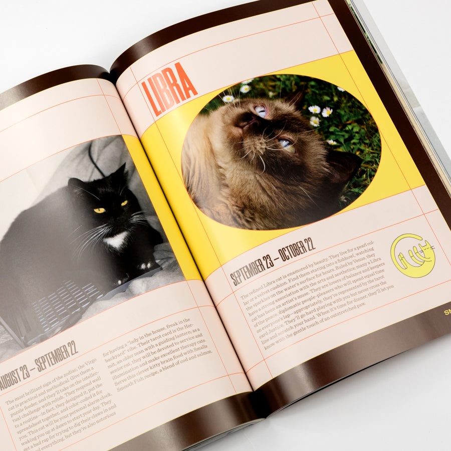 Open book with zodiac sign Libra page featuring a cat and text.