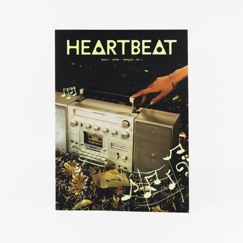 Album cover with a cassette player and hand, featuring the word 'HEARTBEAT'.