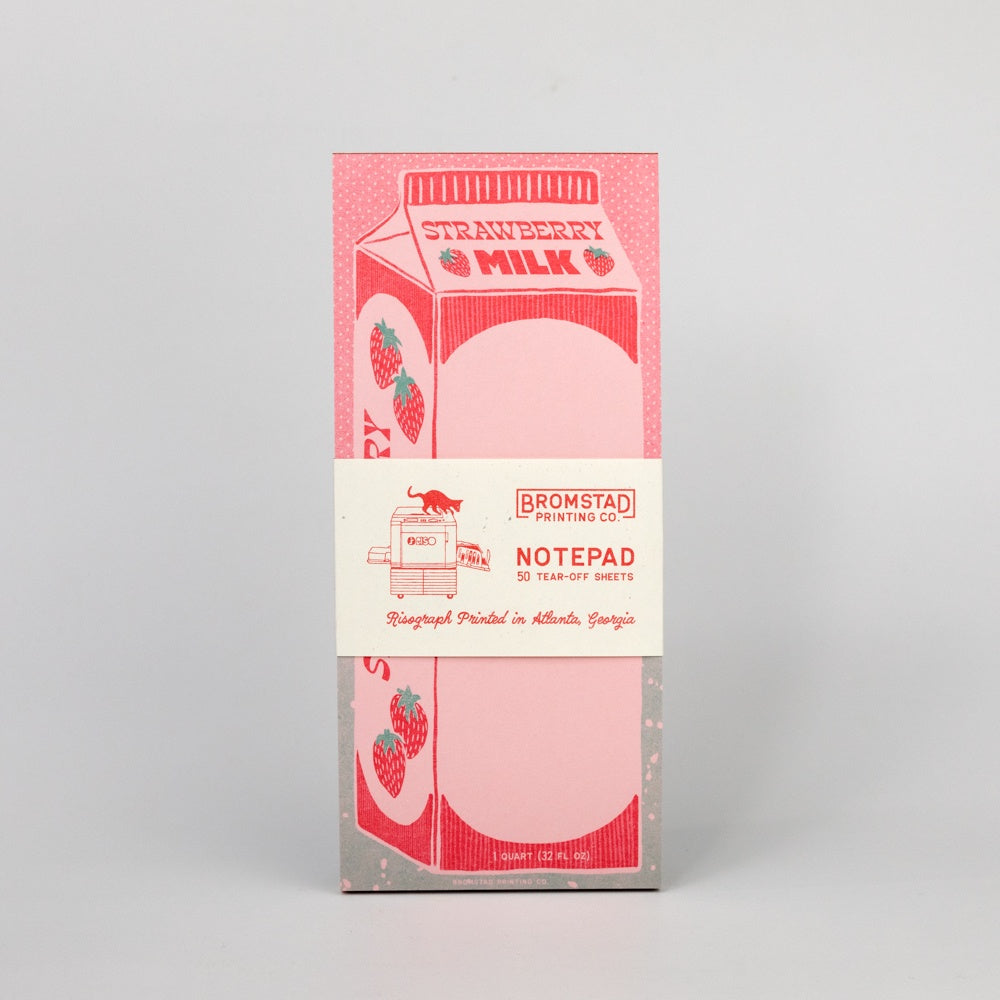 Notepad designed to look like a strawberry milk carton on a gray background