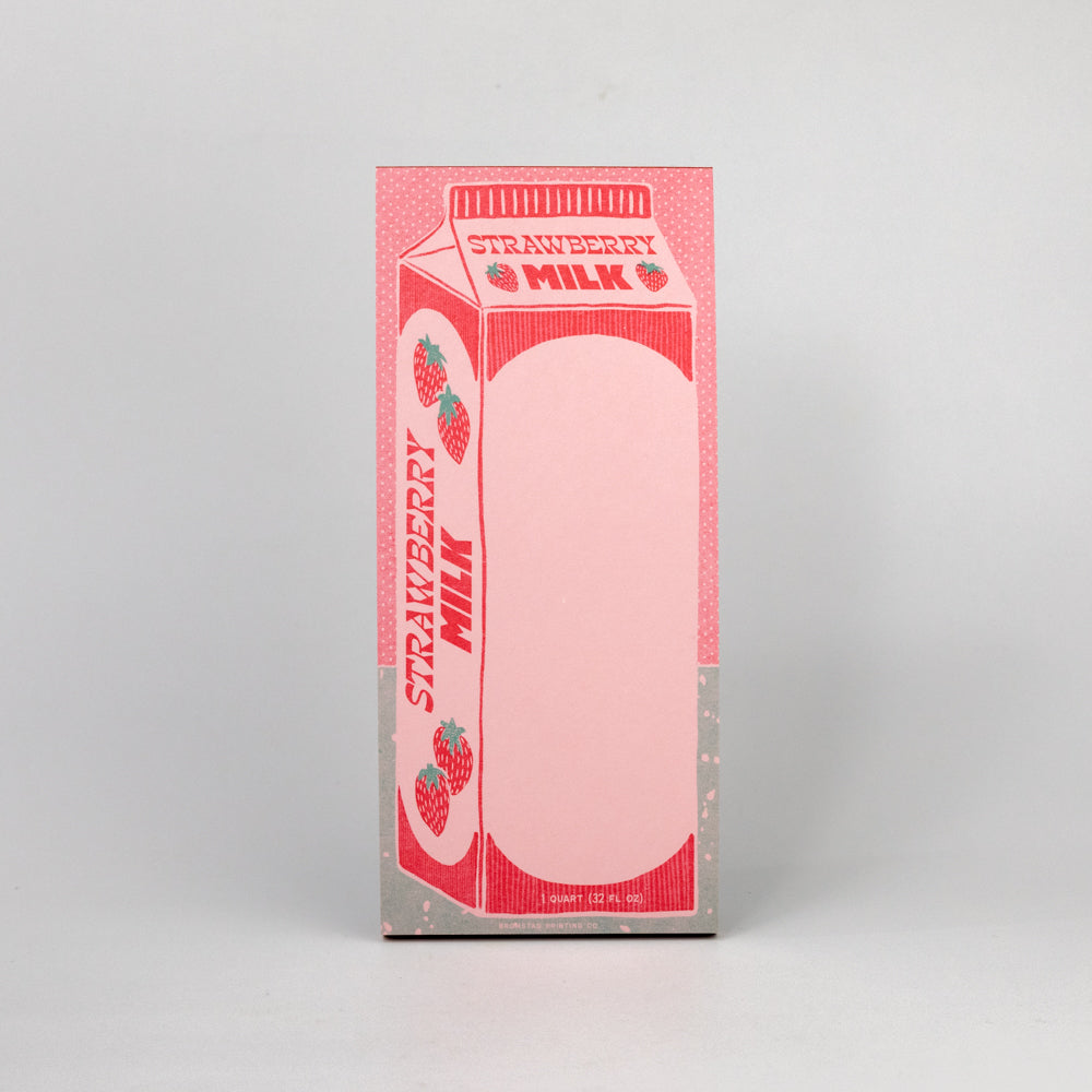 Notepad designed to look like a strawberry milk carton on a gray background