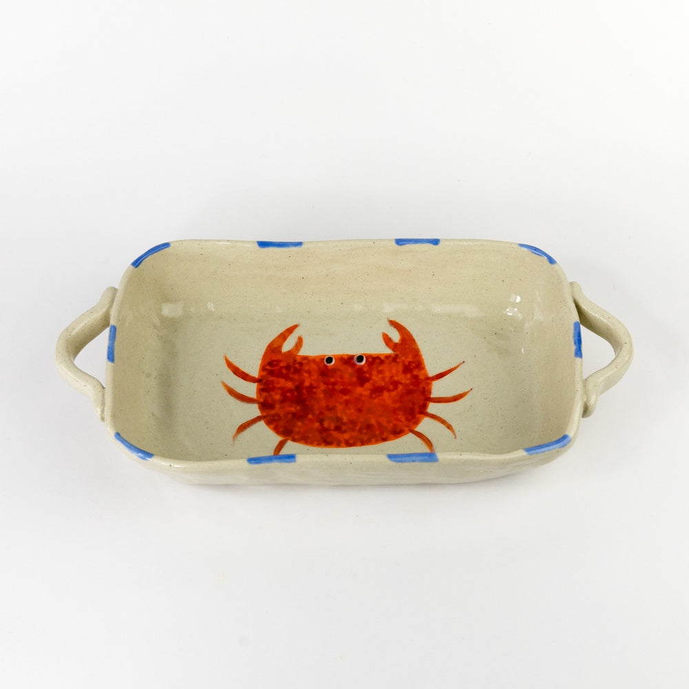 Rectangular ceramic dish with a red crab design on a beige background