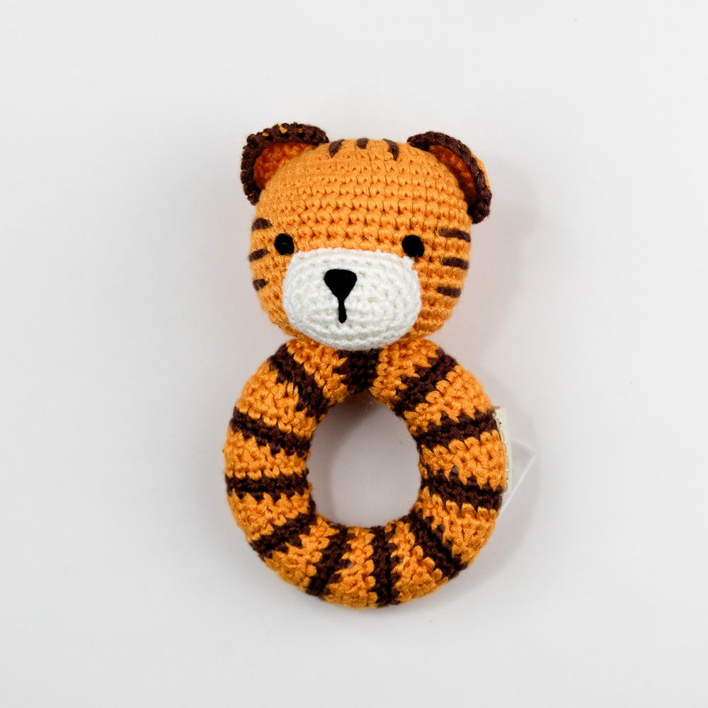 Crocheted tiger rattle toy on a white background