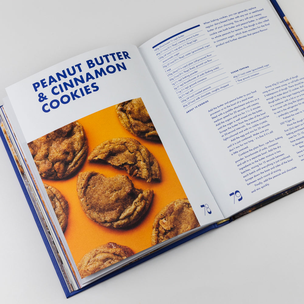 Open cookbook showing a recipe for peanut butter cinnamon cookies on a white background