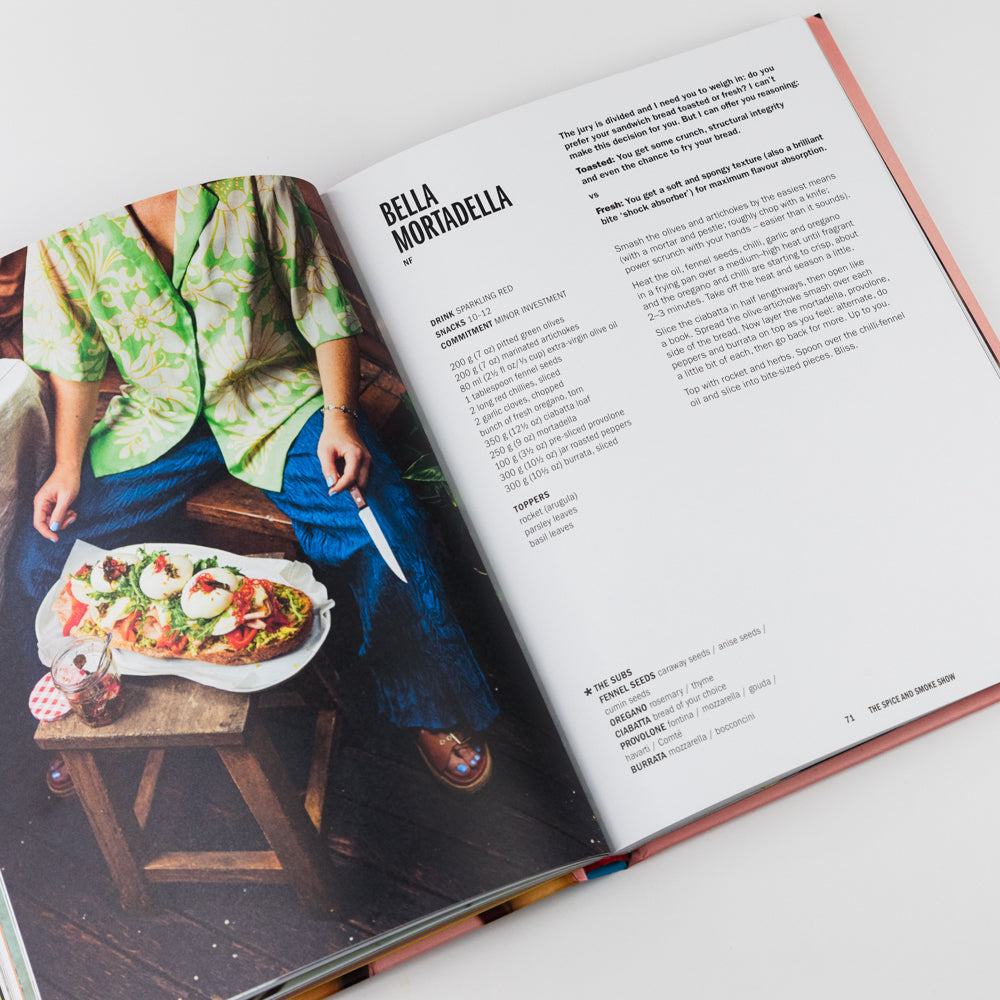 Open book showing a recipe for Bella Mortadella with an illustration of a person holding a pizza.