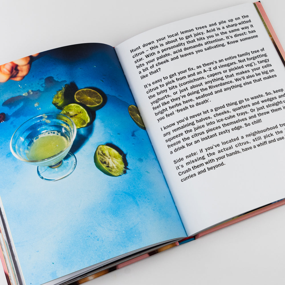 Open book with a page showing a recipe for a drink featuring limes and a glass of green liquid.