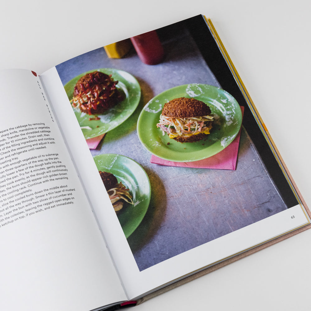 Open cookbook showing a page with images of food on green plates.
