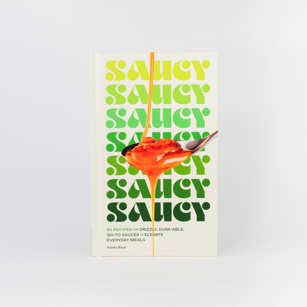 Book cover with 'Saucy' text and a spoonful of sauce on a white background