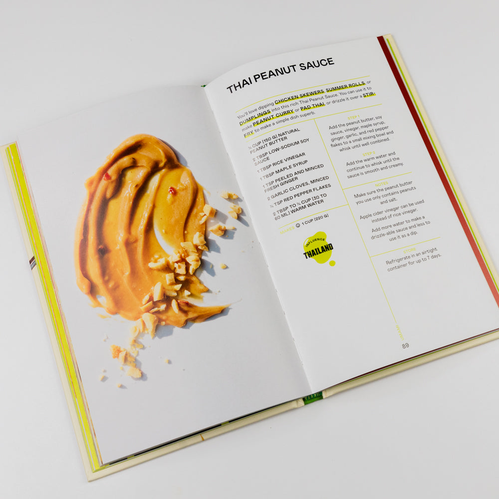 Open book showing a recipe for Thai peanut sauce with a picture of the sauce on a white background.