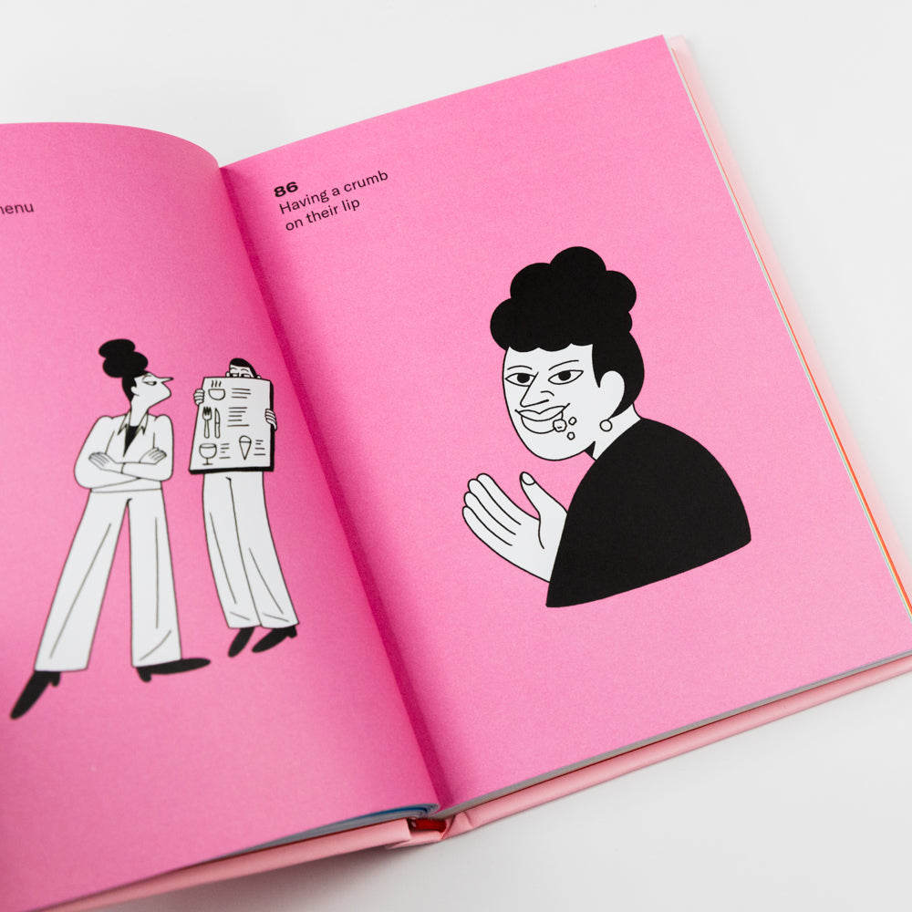 Open book with pink pages featuring black and white illustrations on a white background