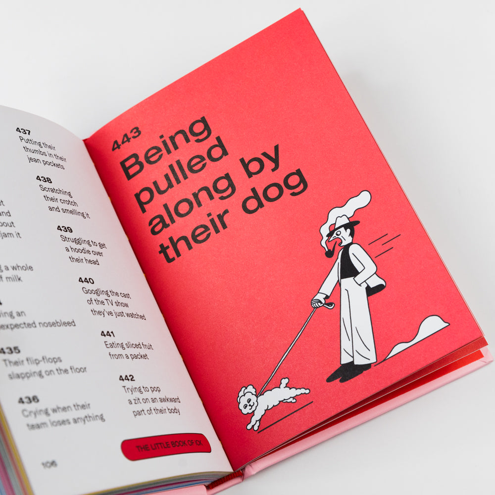 Open book with a red page titled 'Being pulled along by their dog' on a white background