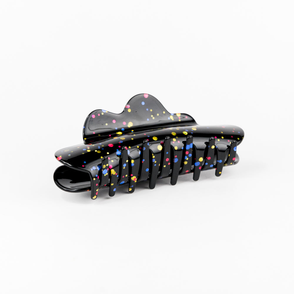 Black hair clip with colorful speckles on a white background