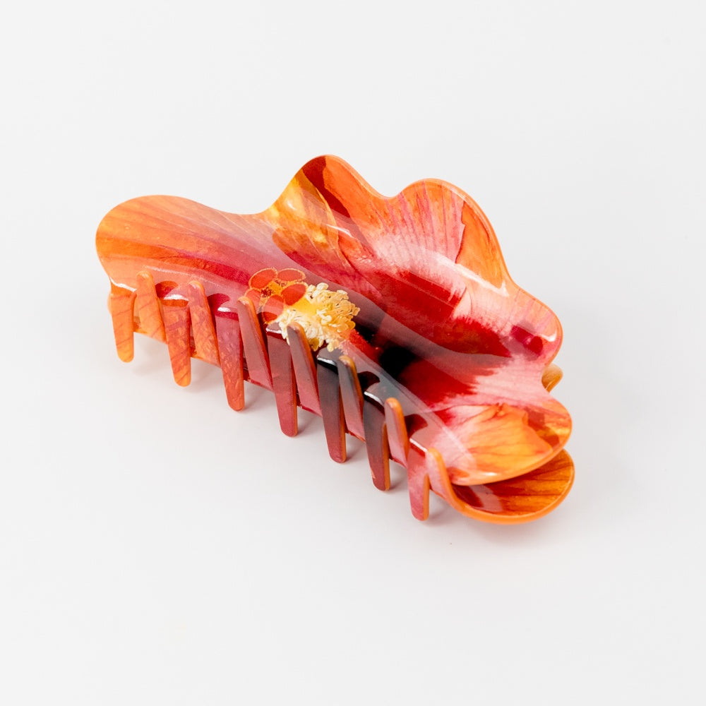 Hair claw with a photo-realistic hibiscus pattern on a white background