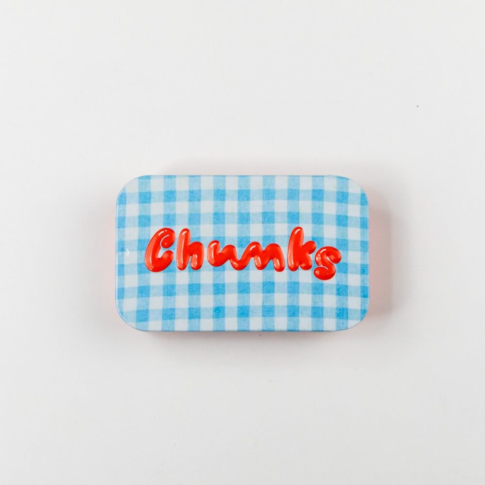 Rectangular tin with blue and white checkered pattern and red text on a white background