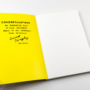 Open book with yellow page and black text on a white background