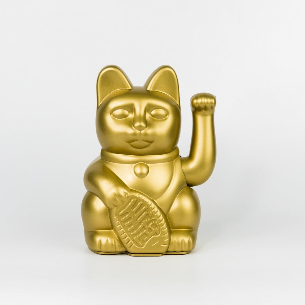 Gold waving cat figurine on a white background