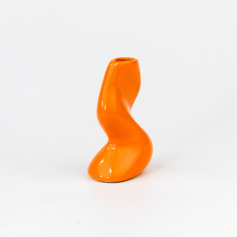 Orange twisted vase on a white background