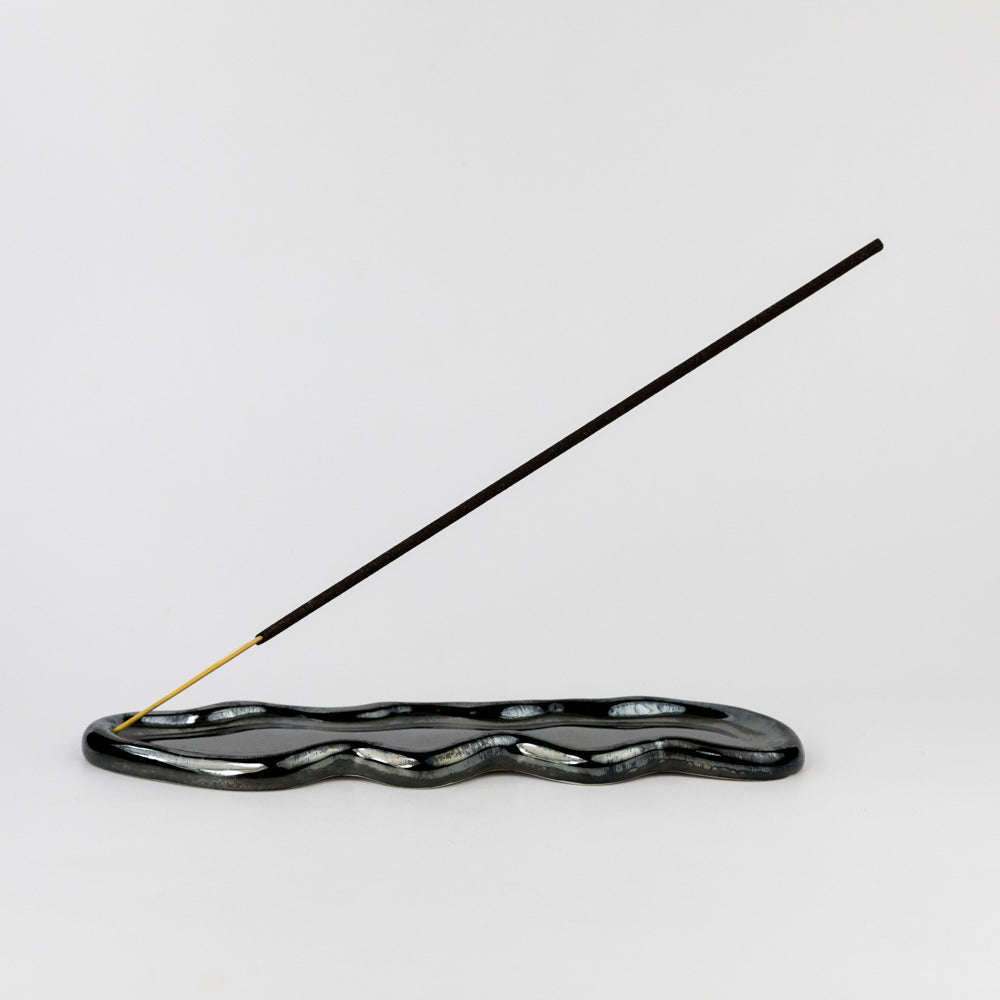 Black wavy ceramic dish on a white background