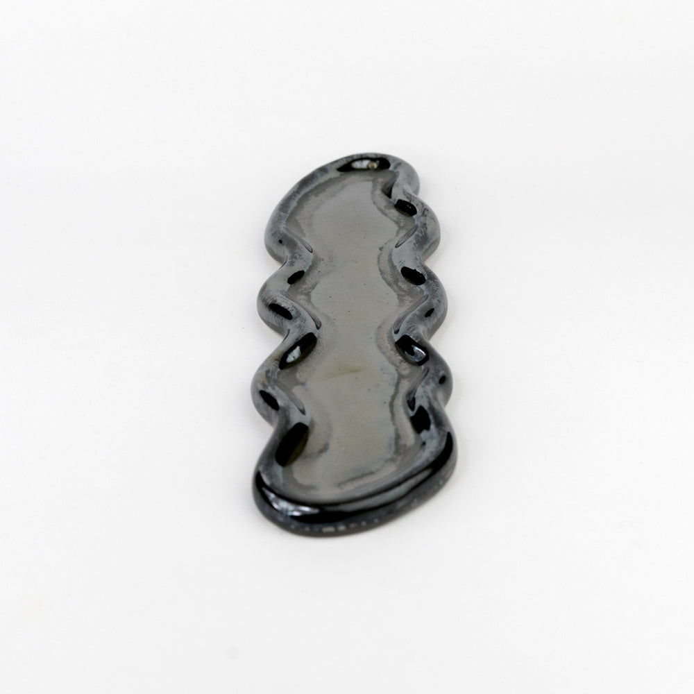 Black wavy ceramic tray on a white background
