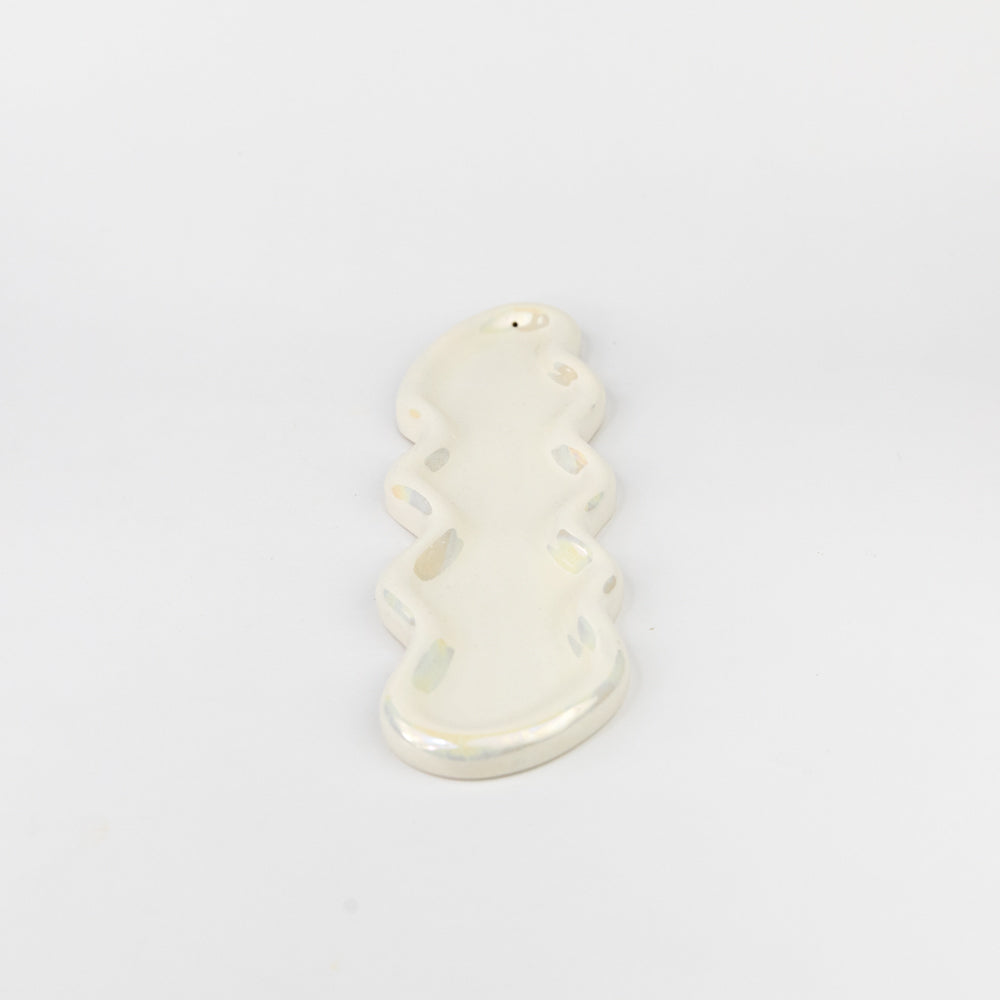 White ceramic snowman ornament on a light gray background