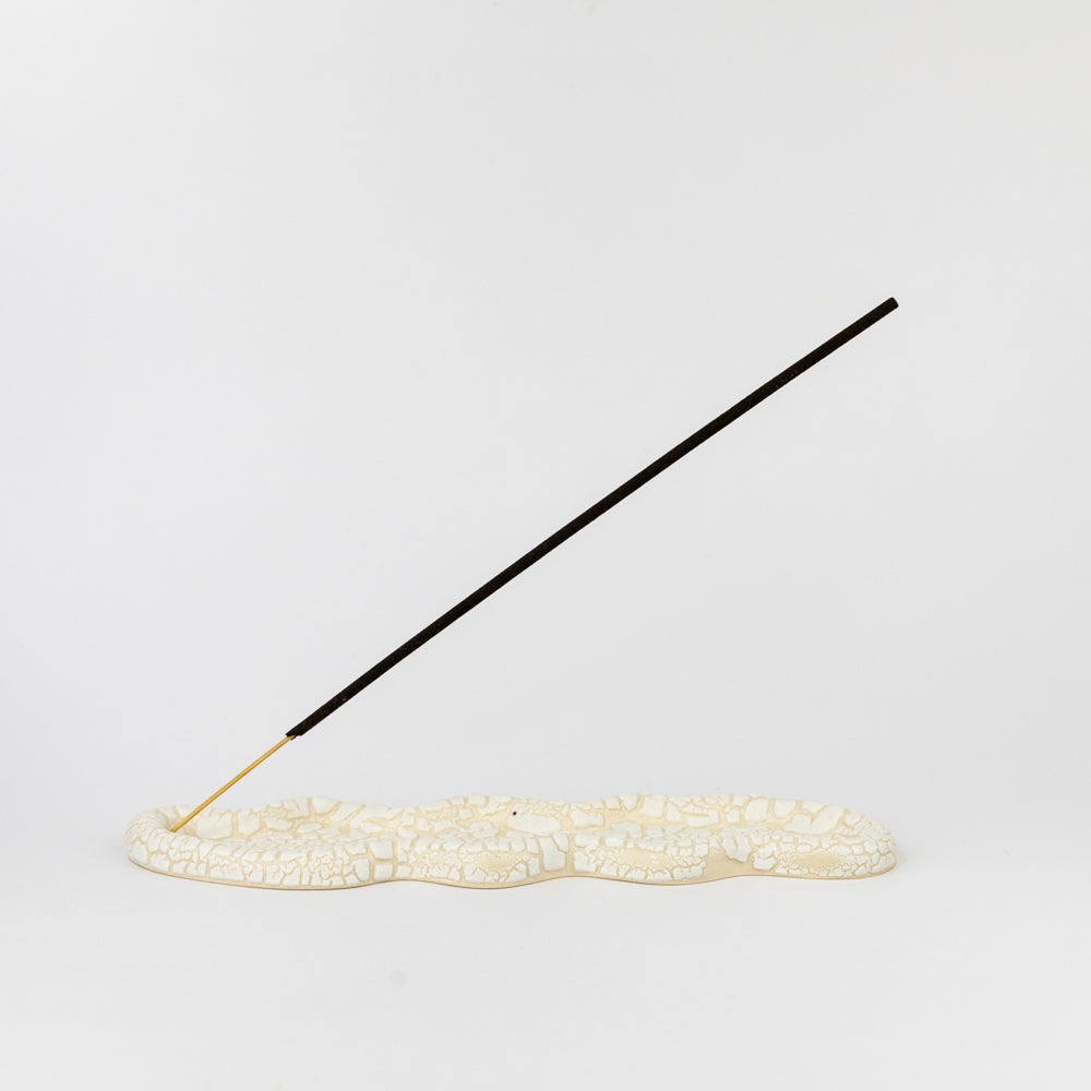 Incense stick on a white surface