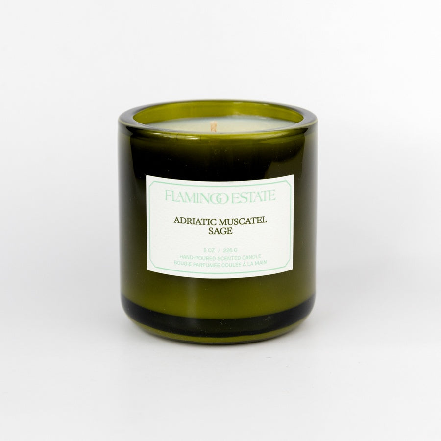 Green candle with a label on a white background