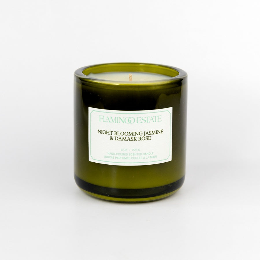 Green candle with a label on a white background