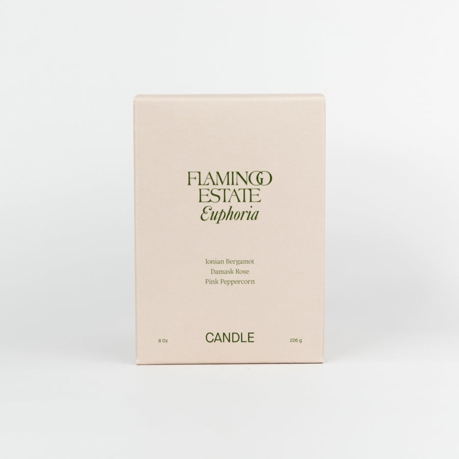 Green candle with a label on a white background