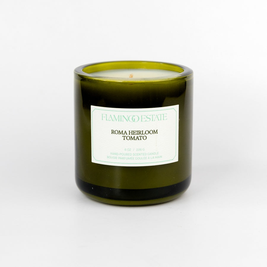 Green candle with a label on a white background