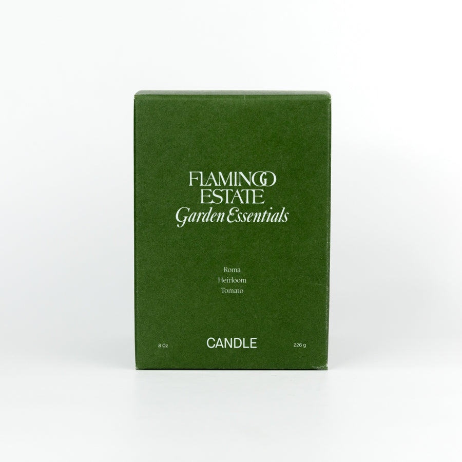 Green candle with a label on a white background