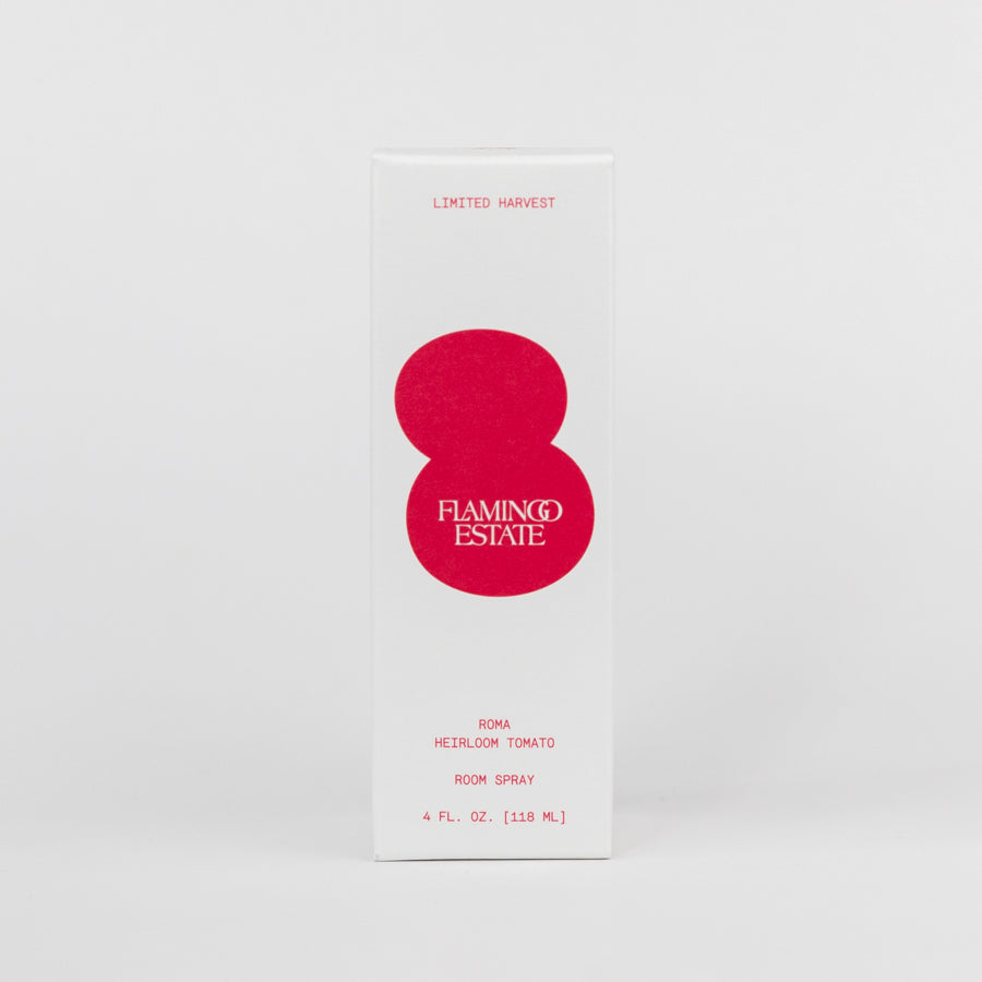 Brown room spray bottle with red label on a white background