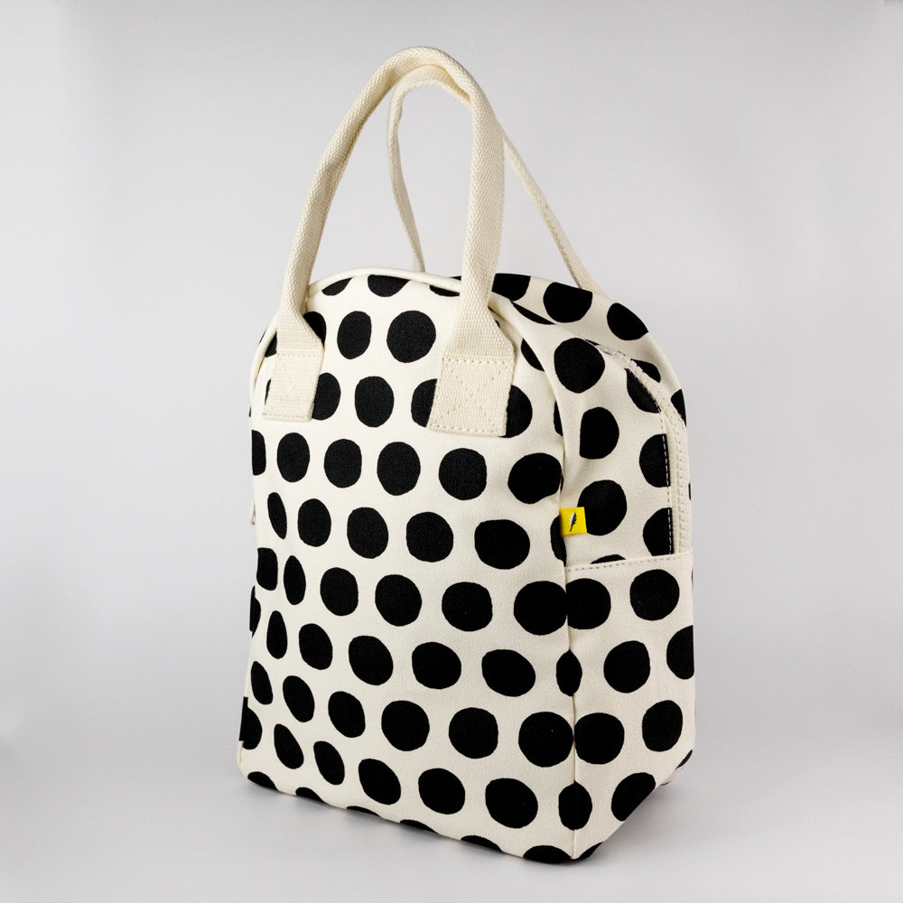 Polka dot lunch bag with yellow Fluf label on a light gray background