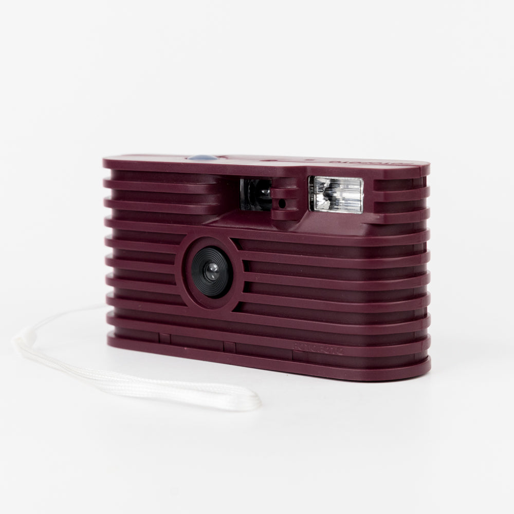 Maroon instant camera on a white background