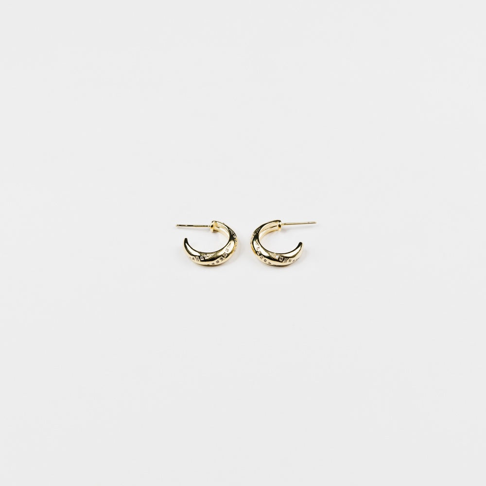 A pair of small gold crescent-shaped hoop earrings with a textured, hammered finish, displayed on a clean white background.