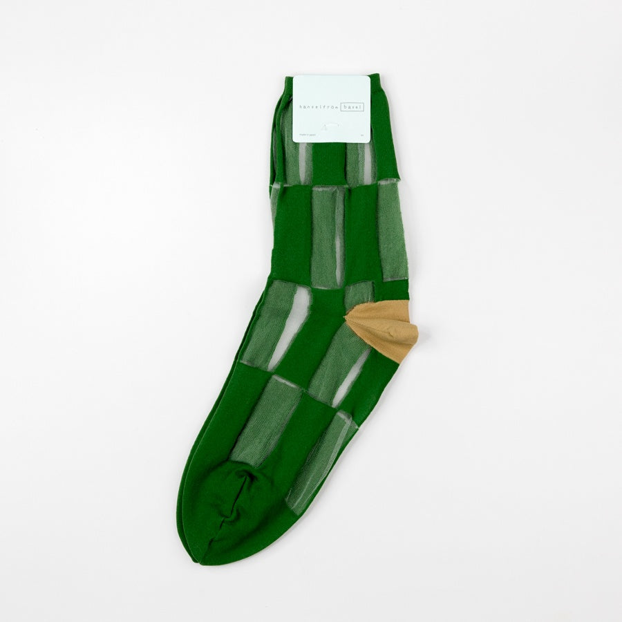 Green sheer sock with a brown heel on a white background
