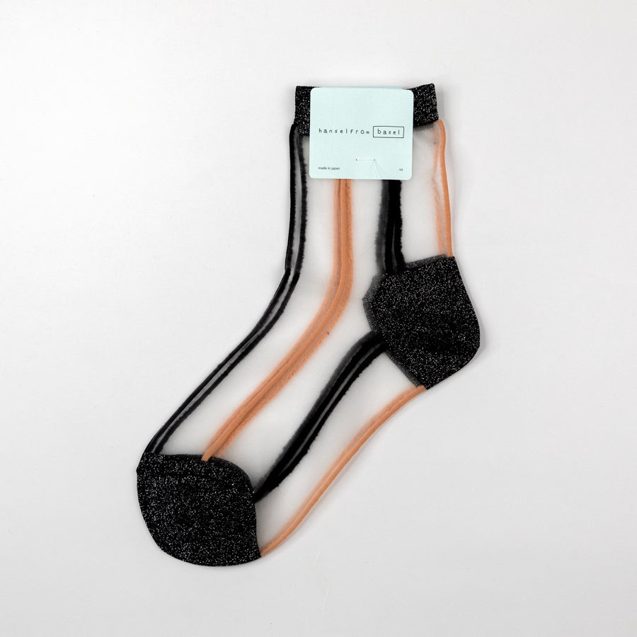 Pair of black and beige socks with a visible brand label on a light gray background