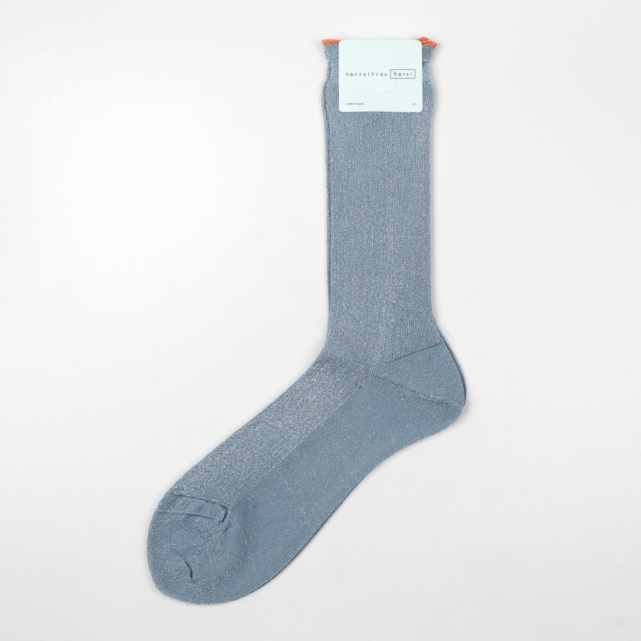 Blue sock with a brand label on a light gray background