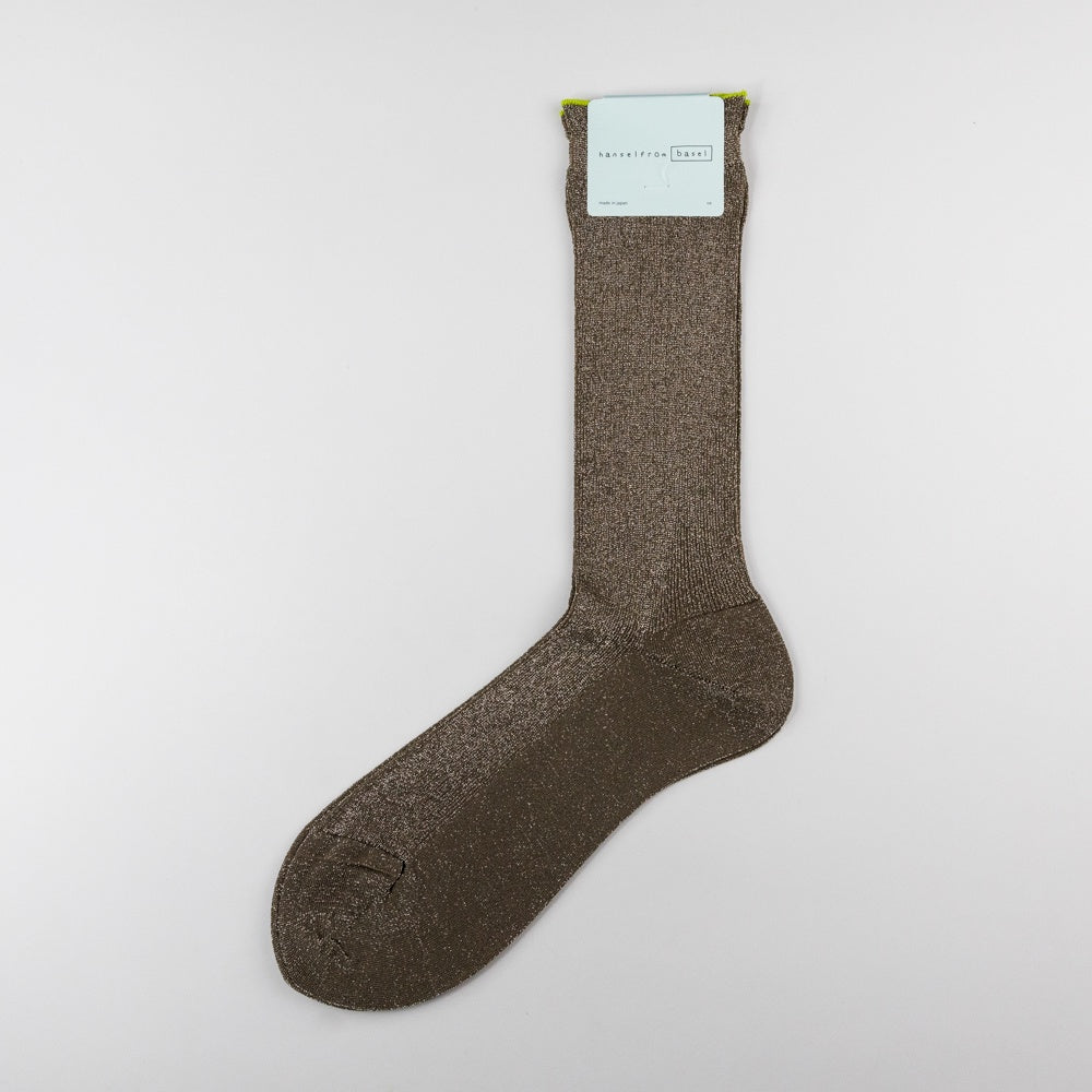 Brown sock with a label on a light gray background