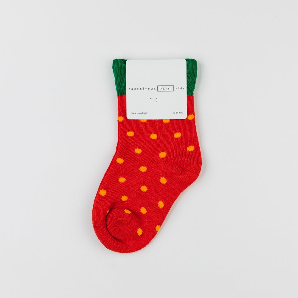 Red sock with yellow dots on a white background