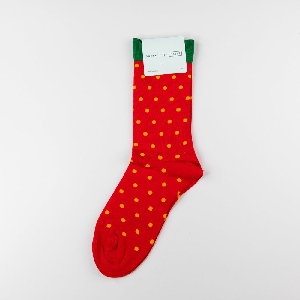 Red sock with yellow dots on a white background
