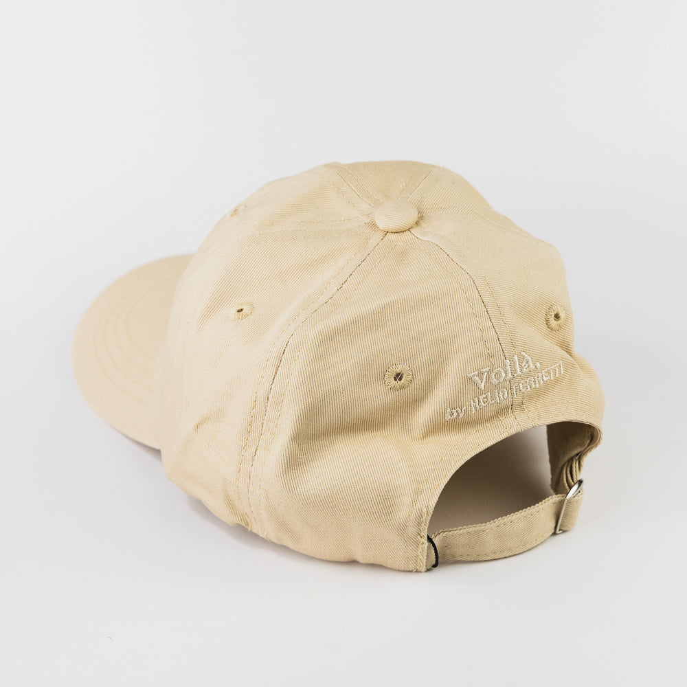 Beige cap with colorful text on a light gray background