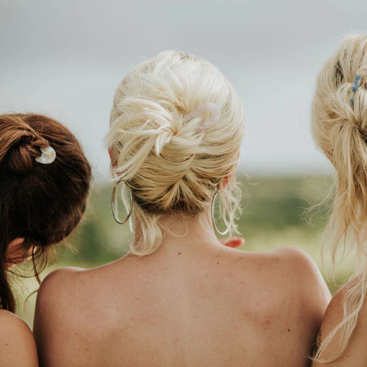 Pink hair clip on a light gray background