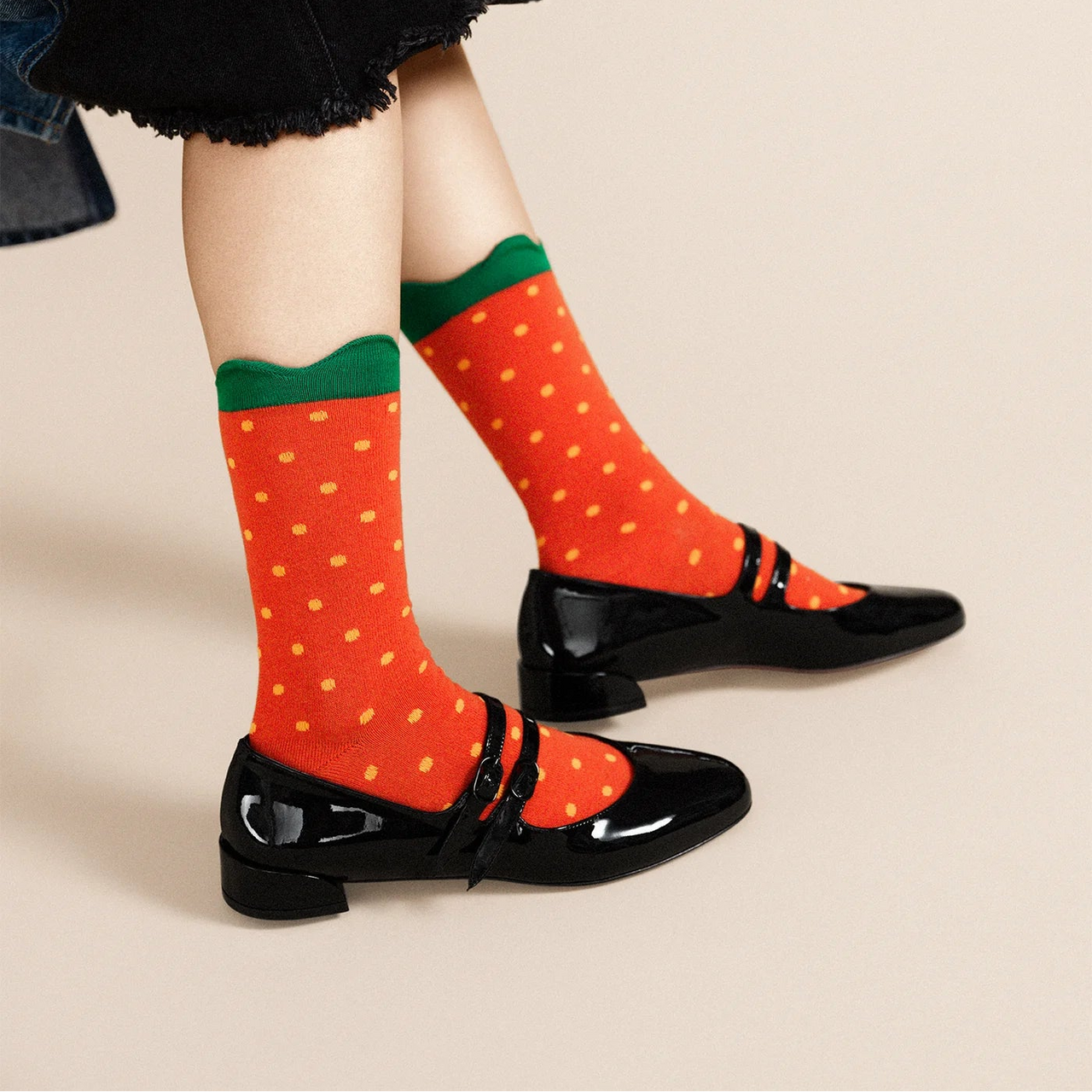 Red sock with yellow dots on a white background