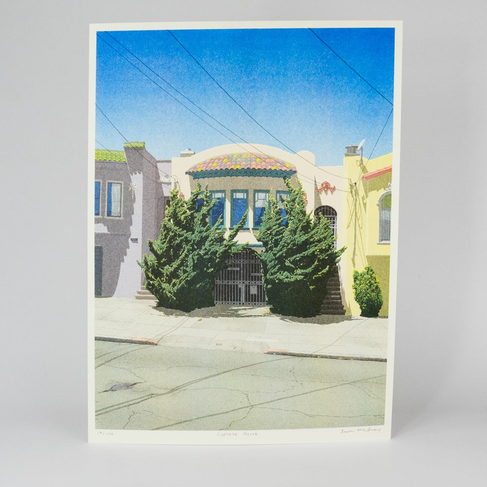 Colorful building with green trees on a street corner under a blue sky.