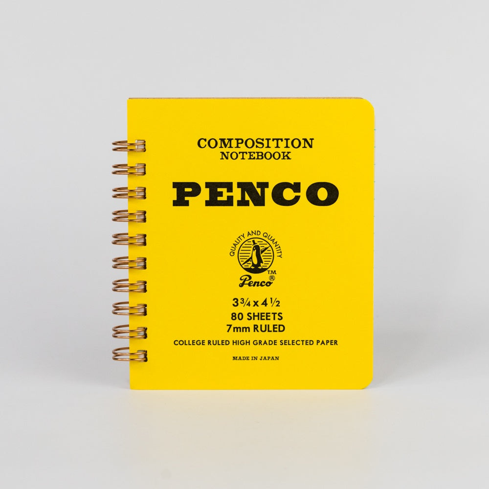 Yellow composition notebook with 'Penco' branding on a light gray background
