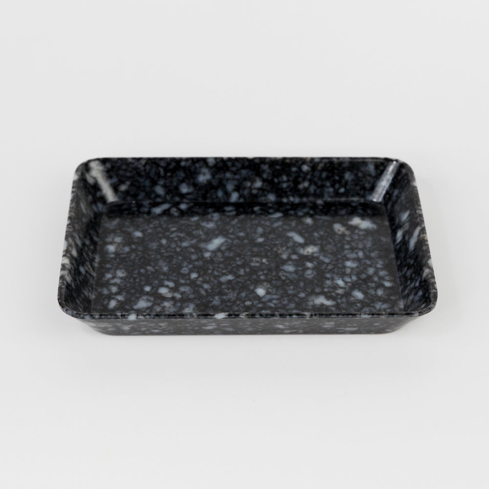 Black speckled rectangular tray on a white background