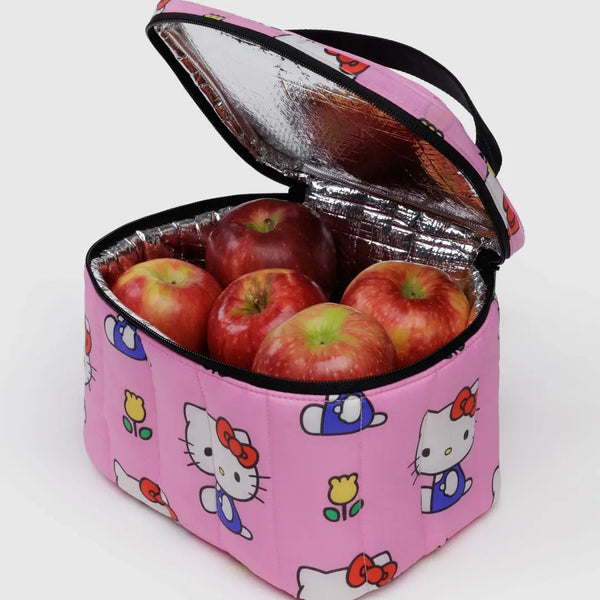 Pink insulated lunch bag with Hello Kitty designs containing red apples on a white background