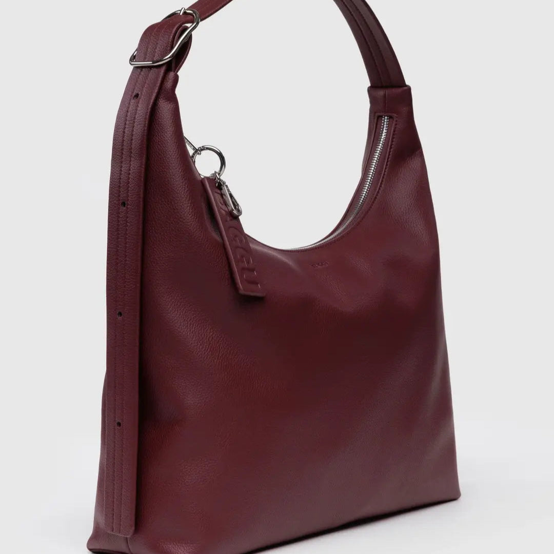 Maroon handbag on a light gray background